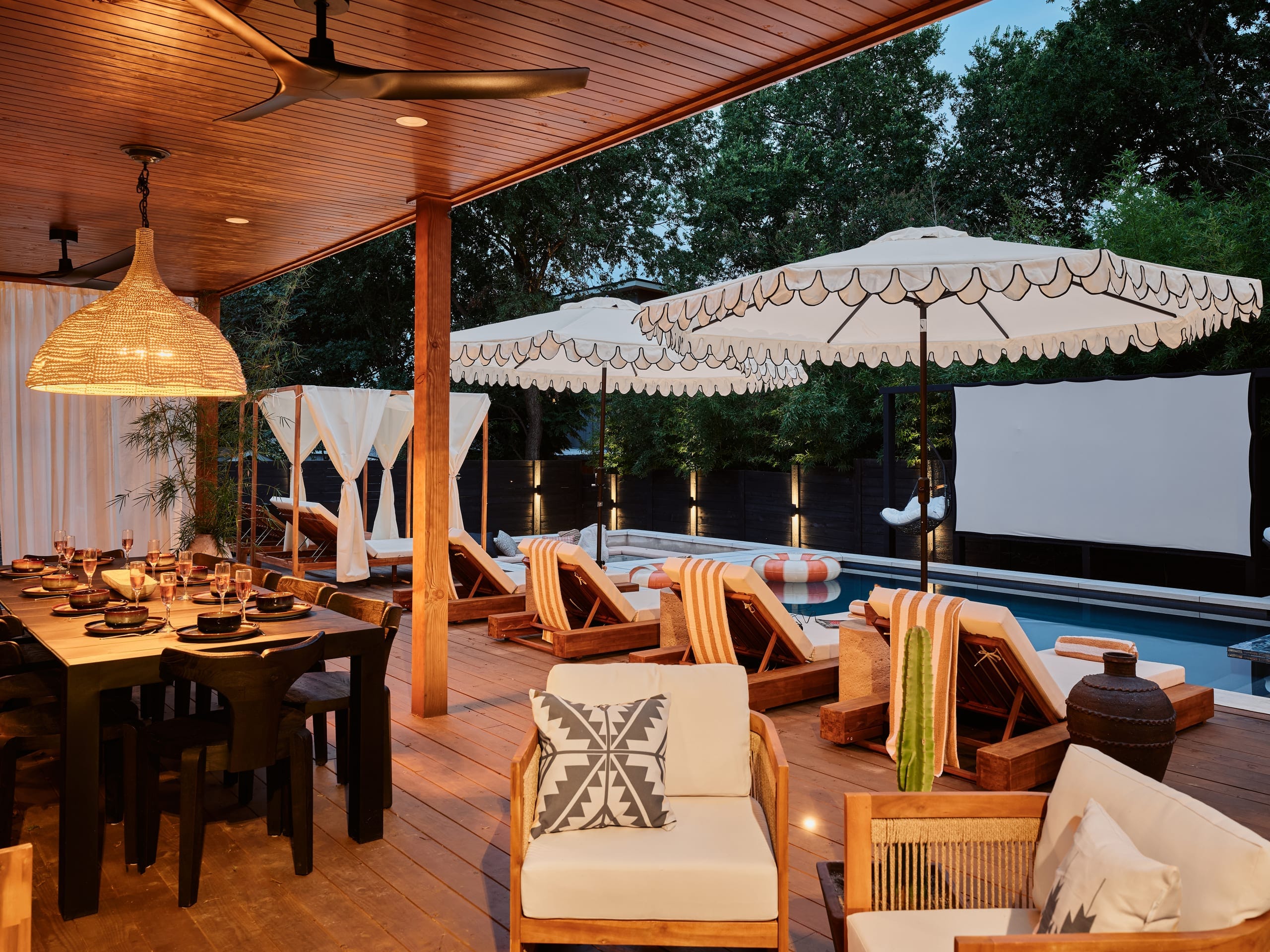 Covered pergola with outdoor dining and the 120" cinema screen